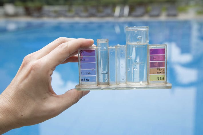 hand holding pool maintenance kit