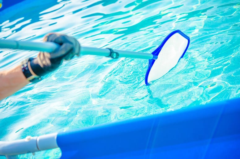 Swimming Pool Man Using Filter to Clean
