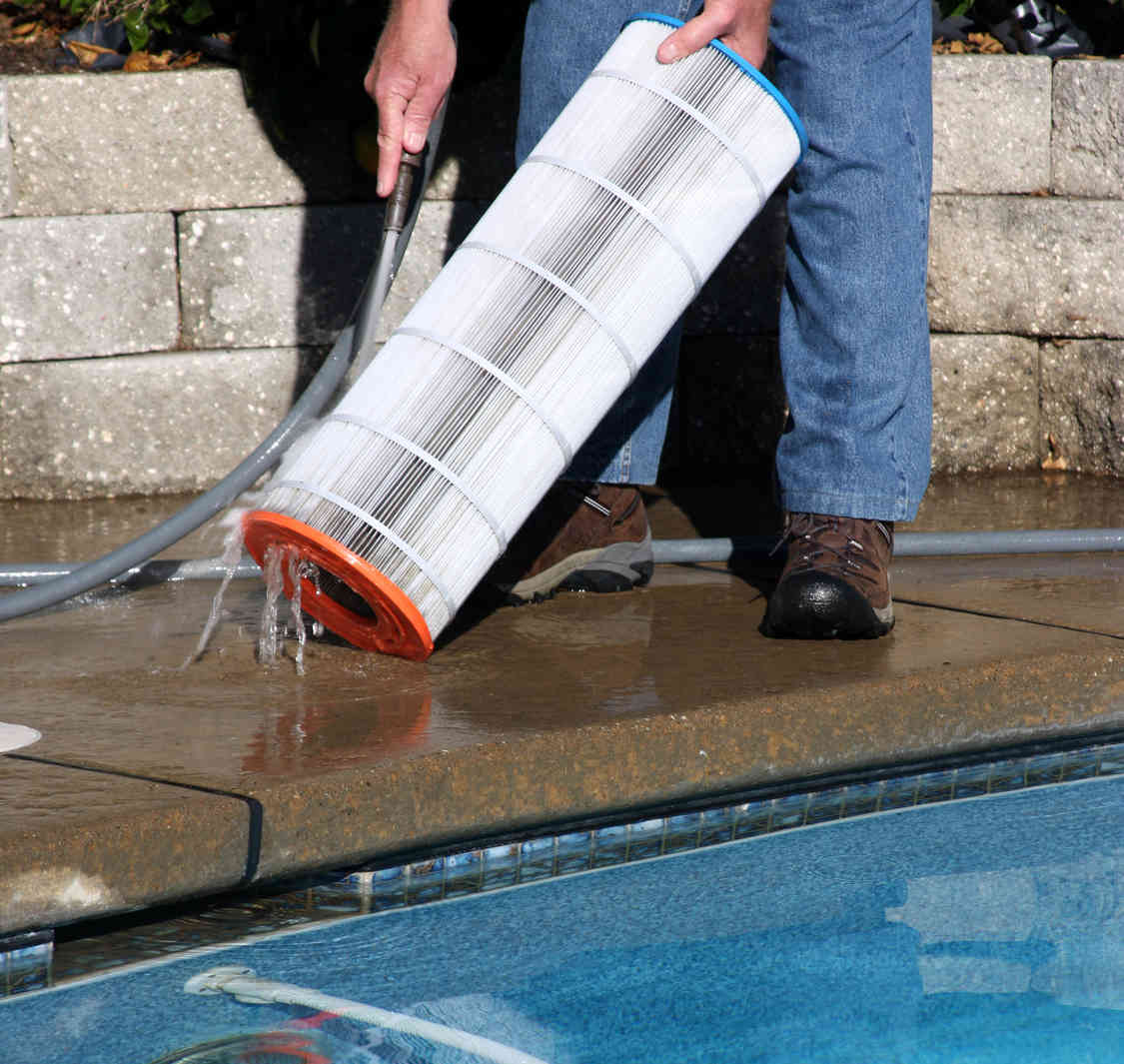 man rinsing out pool filter